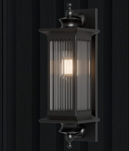 A timeless black outdoor wall lantern featuring ribbed glass panels and a classic silhouette, designed to provide warm, elegant illumination for exterior spaces.
