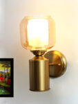 Modern Brass Wall Sconce – Amber Tinted Jar Glass