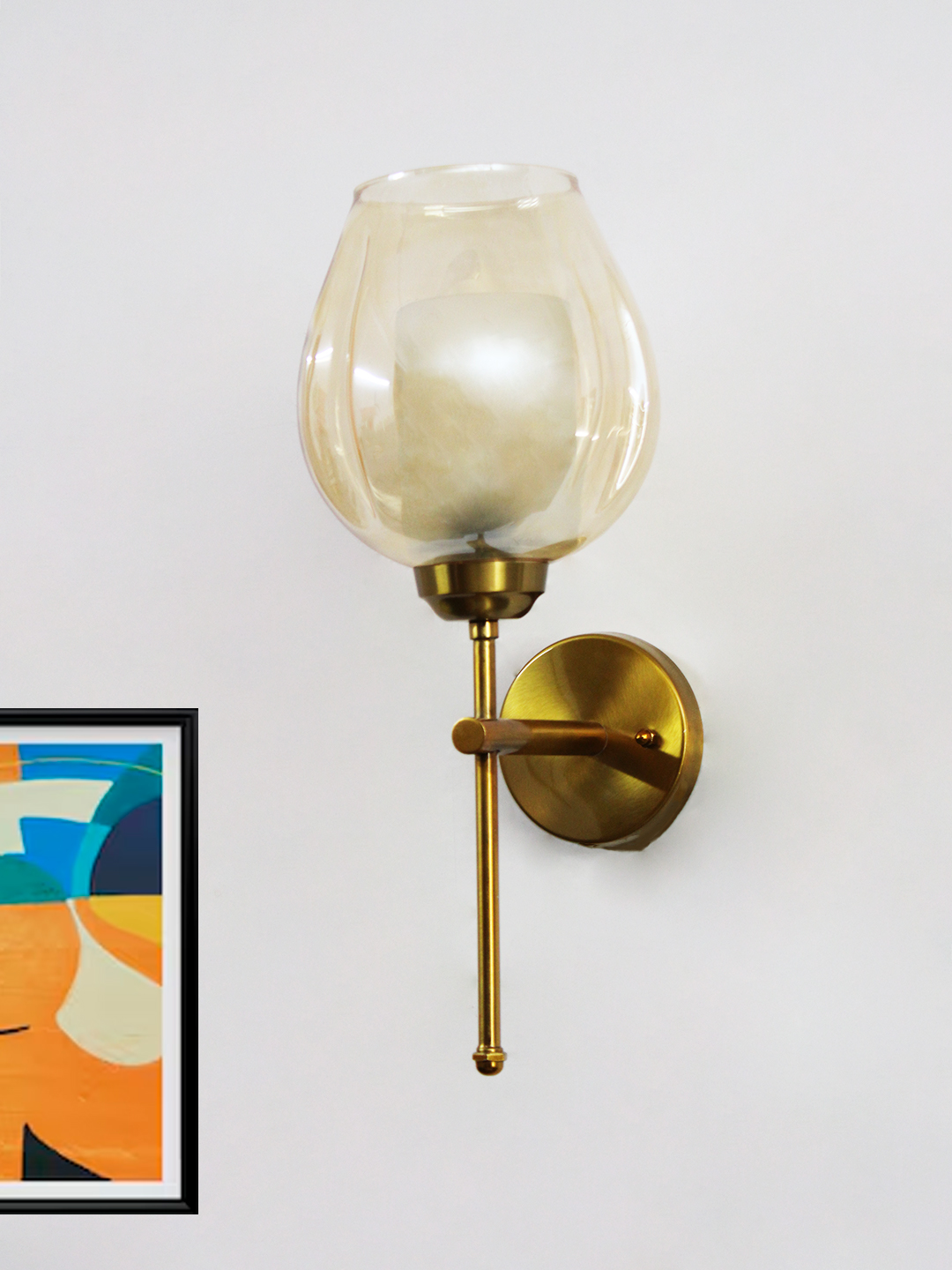 Designer Brass Wall Sconce Amber Glass Lighting Modern wall sconce with amber glass shade and gold metal base, providing warm ambient lighting on a clean minimalist interior wall.