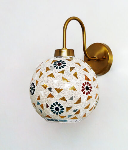 Handcrafted brass wall light with colorful mosaic glass shade casting warm ambient glow on wall decor