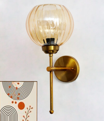 Elegant brass wall light with ribbed amber glass shade, modern wall sconce mounted on a white wall providing warm ambient lighting for stylish interiors