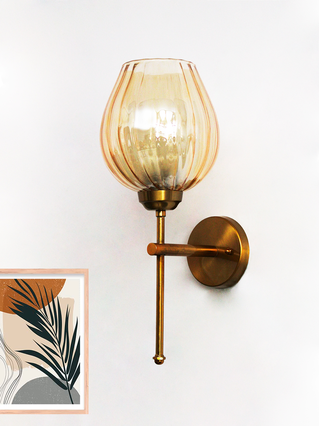Elegant Brass Wall Sconce Amber Glass Lamp Fixture Amber Glass Lamp wall light with textured amber glass shade and brass finish, mounted on a white wall, giving a warm and cozy glow.