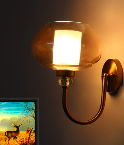 Designer Globe wall light with amber glass shade and brass finish mounted on a wall, featuring a curved arm and warm ambient lighting
