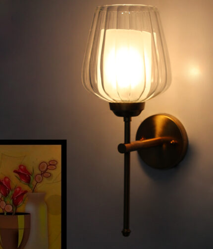 Ribbed Glass Lamp wall light with clear textured glass shade and brushed gold metal base mounted on a white wall, providing elegant ambient lighting for modern interiors.