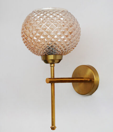 Amber Crystal Globe Glass wall light with textured diamond-pattern glass shade and brushed brass mount on white background