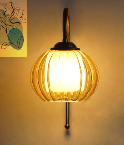 Amber Kharbhuja Glass wall light with ribbed amber glass shade and curved brass arm mounted on wall