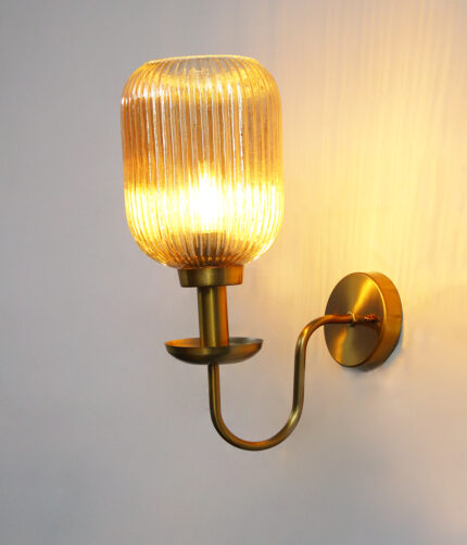 Amber Glass Curved Arm Wall Lamp with ribbed glass shade and antique brass finish for bedroom, living room, and hallway décor