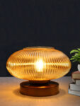 Kachori Glass Table Lamp with wide ribbed amber glass shade, brass finish round base, decorative modern bedside and living room table lamp design