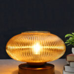 Kachori Glass Table Lamp with wide ribbed amber glass shade, brass finish round base, decorative modern bedside and living room table lamp design