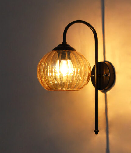 Hanging Black Wall Lamp with amber ribbed glass shade and matte black curved metal wall mount for elegant modern indoor lighting