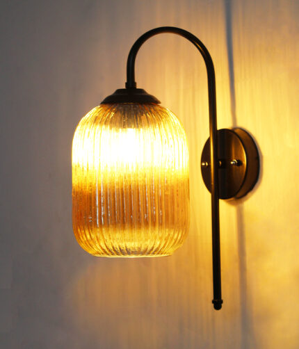 Amber Ribbed Glass wall lamp with amber ribbed cylindrical glass shade and matte black curved metal wall mount for elegant modern indoor lighting