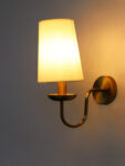 White Fabric Shade Wall Lamp with antique brass finish and curved arm wall sconce for bedroom, living room, and hallway décor