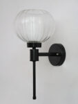 Clear Kharbuja Glass wall light with clear ribbed glass globe shade and matte black metal wall mount for elegant modern indoor lighting