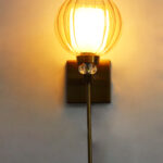 Amber Kharbuja Wall Sconce with amber melon-shaped glass shade, brass finish body, crystal accent, and decorative wall lighting design