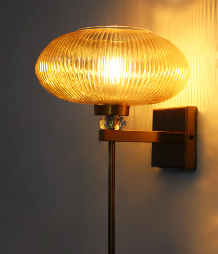 Kachori Glass Wall Light with amber ribbed glass shade, brass finish wall mount, decorative crystal accent and modern vintage wall sconce design