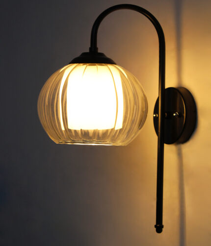 Downward Globe Black Wall Lamp with clear ribbed globe glass shade and matte black curved metal wall mount for elegant modern indoor lighting