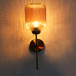 Amber Ribbed Glass Wall Lamp with ribbed amber glass shade and brass finish metal wall mount for elegant modern indoor lighting
