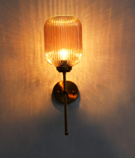 Amber Ribbed Glass Wall Lamp with ribbed amber glass shade and brass finish metal wall mount for elegant modern indoor lighting