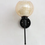 Amber Kharbuja Glass wall light with ribbed amber glass globe shade and matte black metal wall mount for elegant modern indoor lighting