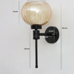 Amber Kharbuja Glass wall light with ribbed amber glass globe shade and matte black metal wall mount for elegant modern indoor lighting