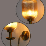 Amber Glass Curved Arm Wall Lamp with ribbed glass shade and antique brass finish for bedroom, living room, and hallway décor