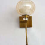 Amber Kharbuja Wall Sconce with amber melon-shaped glass shade, brass finish body, crystal accent, and decorative wall lighting design