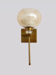 Amber Kharbuja Wall Sconce with amber melon-shaped glass shade, brass finish body, crystal accent, and decorative wall lighting design