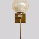 Amber Kharbuja Wall Sconce with amber melon-shaped glass shade, brass finish body, crystal accent, and decorative wall lighting design