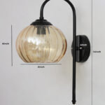 Hanging Black Wall Lamp with amber ribbed glass shade and matte black curved metal wall mount for elegant modern indoor lighting