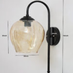 Amber Glass Black Wall Light with amber glass hanging shade and matte black curved metal wall mount for elegant modern indoor lighting