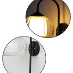 Downward Globe Black Wall Lamp with clear ribbed globe glass shade and matte black curved metal wall mount for elegant modern indoor lighting