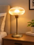 Aurora Ribbed Glass table lamp with wide ribbed amber glass shade and brass base, modern decorative lighting for bedside or living room use