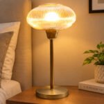 Aurora Ribbed Glass table lamp with wide ribbed amber glass shade and brass base, modern decorative lighting for bedside or living room use