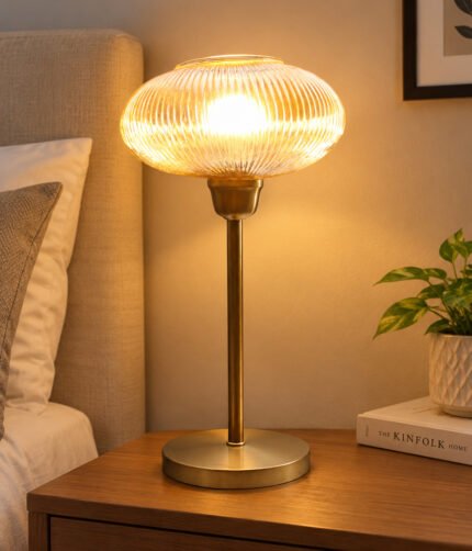 Aurora Ribbed Glass table lamp with wide ribbed amber glass shade and brass base, modern decorative lighting for bedside or living room use