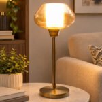 Amber Kachori Vintage table lamp with rounded amber glass shade and brass base, providing warm decorative lighting for bedside or living room use
