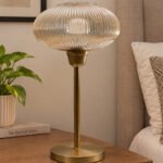 Aurora Ribbed Glass table lamp with wide ribbed amber glass shade and brass base, modern decorative lighting for bedside or living room use