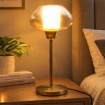 Amber Kachori Vintage table lamp with rounded amber glass shade and brass base, providing warm decorative lighting for bedside or living room use