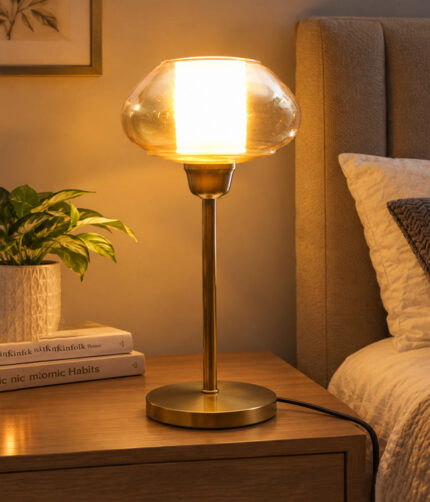Amber Kachori Vintage table lamp with rounded amber glass shade and brass base, providing warm decorative lighting for bedside or living room use