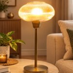 Aurora Ribbed Glass table lamp with wide ribbed amber glass shade and brass base, modern decorative lighting for bedside or living room use