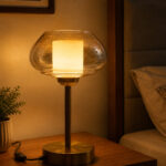 Amber Kachori Vintage table lamp with rounded amber glass shade and brass base, providing warm decorative lighting for bedside or living room use