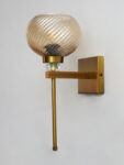 Doom MF Amber Glass wall light with ribbed dome-shaped amber glass shade, brass finish arm, and elegant vertical rod for decorative interior lighting