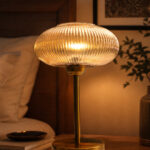 Aurora Ribbed Glass table lamp with wide ribbed amber glass shade and brass base, modern decorative lighting for bedside or living room use