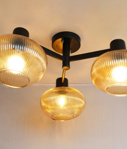 Solara 3-Light chandelier with three ribbed amber glass shades and a matte black metal frame, modern semi-flush ceiling light for dining rooms, living rooms, kitchens, and bedrooms.