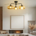 Ribbed Glass Chandelier with three amber ribbed glass shades and a matte black metal frame, modern semi-flush ceiling light for dining room, living room, and kitchen.