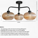 Ribbed Glass Chandelier with three amber ribbed glass shades and a matte black metal frame, modern semi-flush ceiling light for dining room, living room, and kitchen.