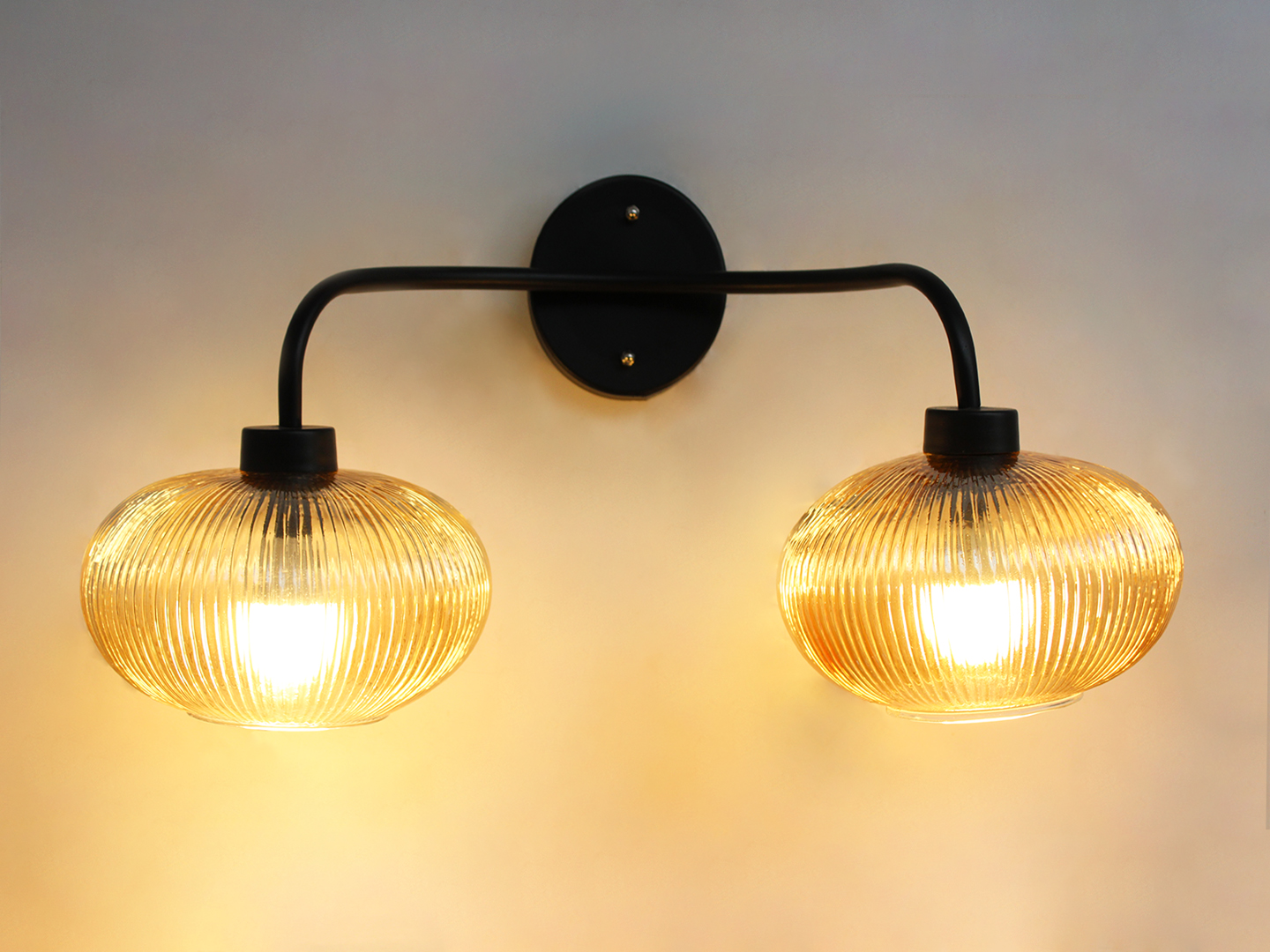 Aurora 2-Light Ribbed Glass Wall Sconce **Alt Text:** **2-Light Ribbed Glass** wall light with dual amber ribbed glass shades and a matte black metal frame, modern wall-mounted fixture for bedrooms, hallways, living rooms, and dining spaces.