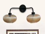 **Alt Text:** **2-Light Ribbed Glass** wall light with dual amber ribbed glass shades and a matte black metal frame, modern wall-mounted fixture for bedrooms, hallways, living rooms, and dining spaces.