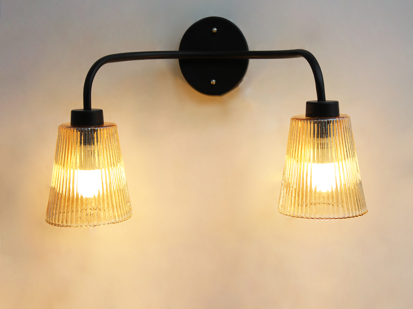 Florence Ribbed Glass Wall Light Florence Ribbed Glass dual-light wall sconce with textured ribbed glass shades and a matte black metal frame, perfect for modern bedrooms, hallways, living rooms, and dining spaces.