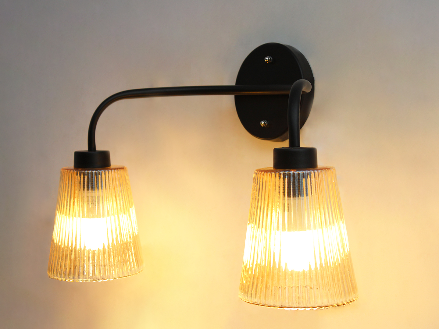 Florence Ribbed Glass Wall Light Florence Ribbed Glass dual-light wall sconce with textured ribbed glass shades and a matte black metal frame, perfect for modern bedrooms, hallways, living rooms, and dining spaces.