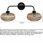 **Alt Text:** **2-Light Ribbed Glass** wall light with dual amber ribbed glass shades and a matte black metal frame, modern wall-mounted fixture for bedrooms, hallways, living rooms, and dining spaces.